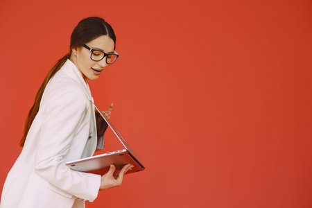Woman standing on a red background