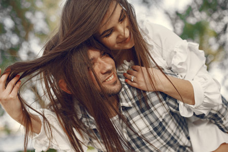 Beautiful couple spend time in a summer park
