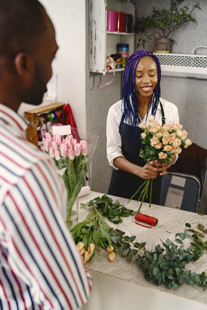 Portrait of joyful African American people in flower store