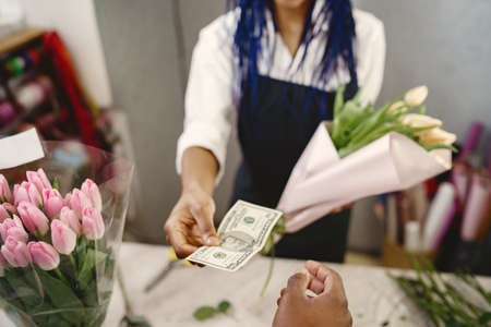 Portrait of joyful African American young woman in flower storeの写真素材