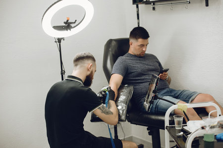 Man doing a tattoo in a tattoo salon