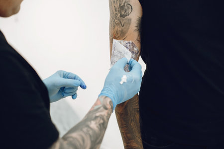 Man doing a tattoo in a tattoo salon