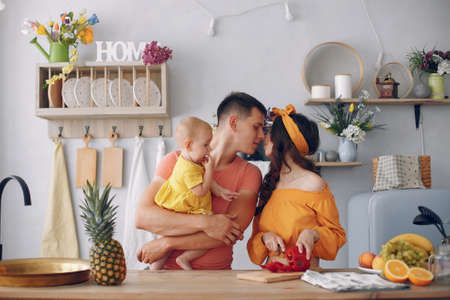 Beautiful family prepare food in a kitchenの写真素材