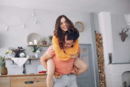 Beautiful couple spend time in a kitchenの写真素材