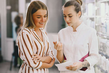 Woman pharmacist checking medicine in pharmacyの写真素材
