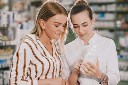 Woman pharmacist checking medicine in pharmacyの写真素材