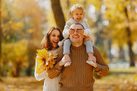 Cute and stylish family playing in a autumn fieldの写真素材
