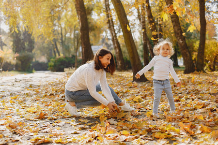 Cute and stylish family in a autumn parkの写真素材