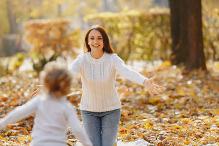 Cute and stylish family in a autumn parkの写真素材