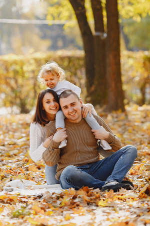 Cute and stylish family playing in a autumn fieldの写真素材