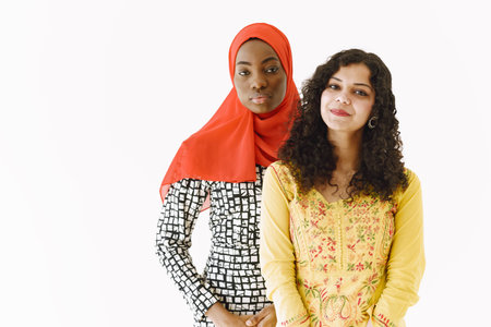 African and Asian women together on white background