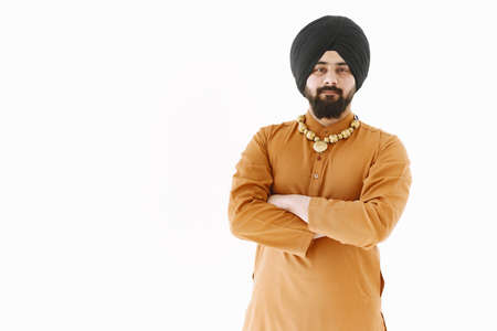 Young muslim man posing casually over white wall. Studio, isolated.の写真素材