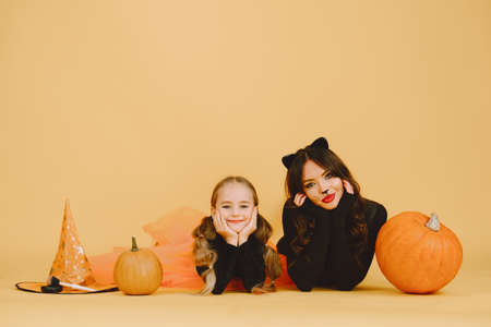 Mother and daughter in haloween costumes pose isolatedの写真素材