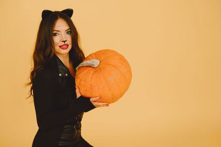 Woman with cat makeup and ears on color backgroundの写真素材