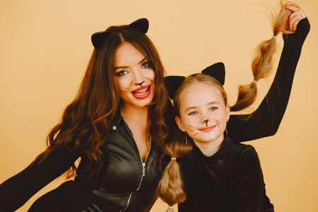 Mother and daughter in haloween costumes pose isolatedの写真素材