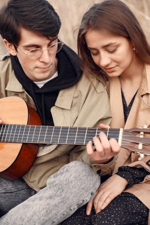 Beautiful couple spend time in a autumn fieldの写真素材