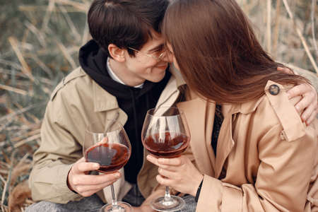 Beautiful couple spend time in a autumn fieldの写真素材