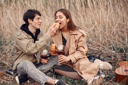 Beautiful couple spend time in a autumn fieldの写真素材