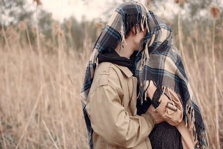 Beautiful couple spend time in a autumn field