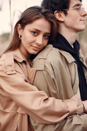 Beautiful couple spend time in a autumn fieldの写真素材