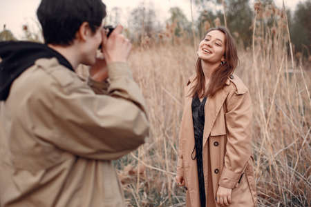 Beautiful couple spend time in a autumn fieldの写真素材