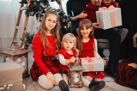 Big family sitting at home near christmas treeの写真素材