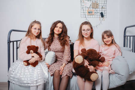 Cute sisters in a cute dress at homeの写真素材