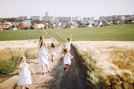 Mothers with daughters playing in a autumn fieldの写真素材