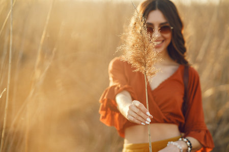 Stylish woman spending time in a summer field
