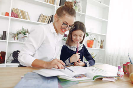 Tutor with litthe girl studying at homeの写真素材