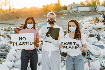 Eco activists at garbage dump with signsの写真素材