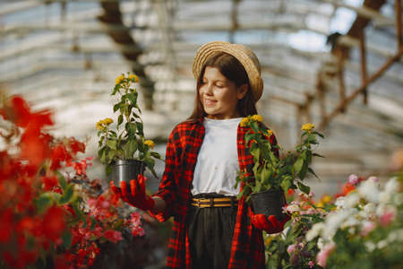 little girl working in a greenhouseの写真素材