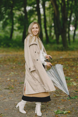 Elegant woman in a autumn parkの写真素材