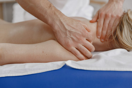 Man doctor do massage to female body