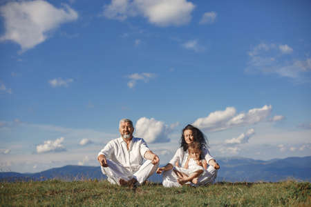 Grandparents in summer mountains with granddaughterの写真素材