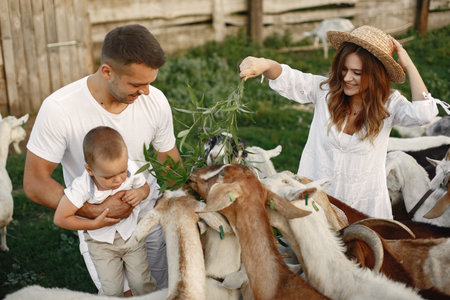 Family spending time together outside with a goat
