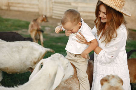 Family spending time together outside with a goatの写真素材