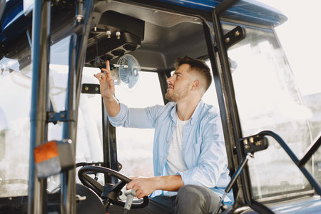 Male sitting comfortably on a big blue tractor