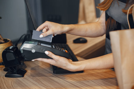 Cashier pays by card through the terminalThe cashier pays by card through the terminal.