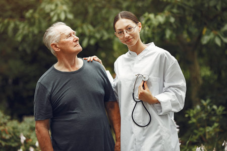 Happy elderly patient with helpful kind doctor