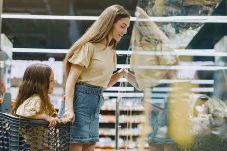 The family buys groceries at the supermarketの写真素材