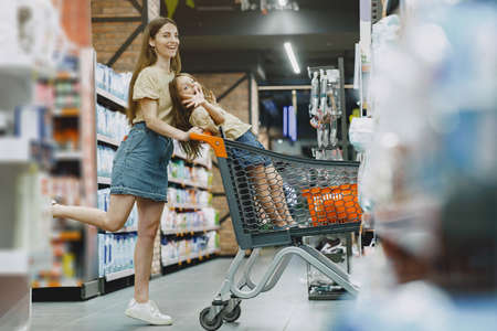 Family choosing school stationery in the supermarketの写真素材