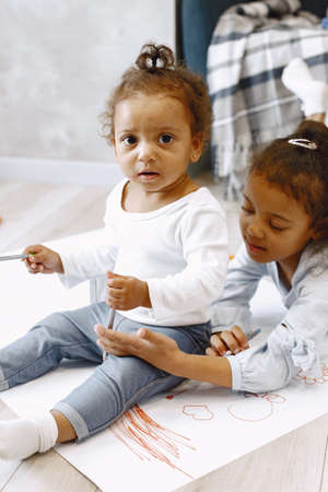 African-american girls lying on floor and drawing.の写真素材