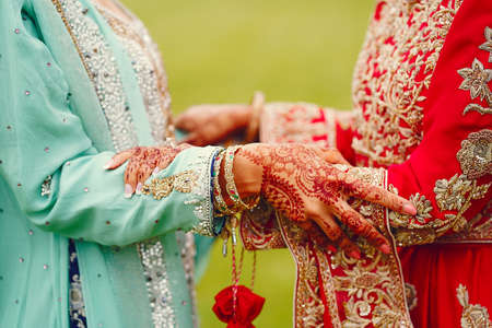 hindu bride walks behind husband holding garbの写真素材