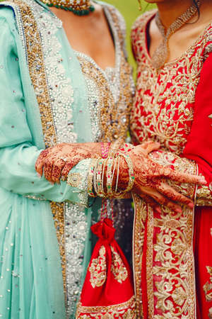 hindu bride walks behind husband holding garbの写真素材