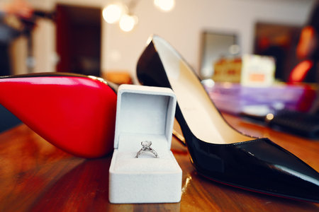 wedding rings close up on brides shoes.