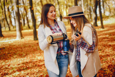 Beautiful girls have fun in a autumn parkの写真素材