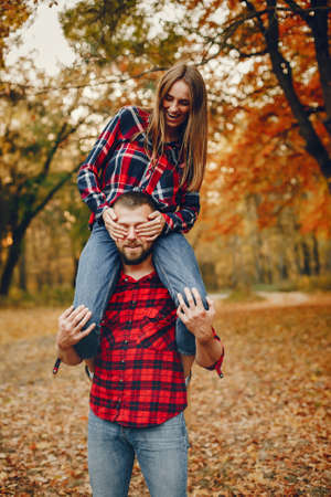 Elegant couple spend time in a autumn parkの写真素材