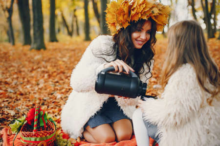 Cute and stylish family in a autumn parkの写真素材