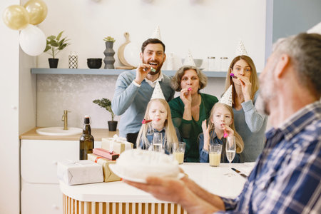 Family celebrating birthday in the kitchen